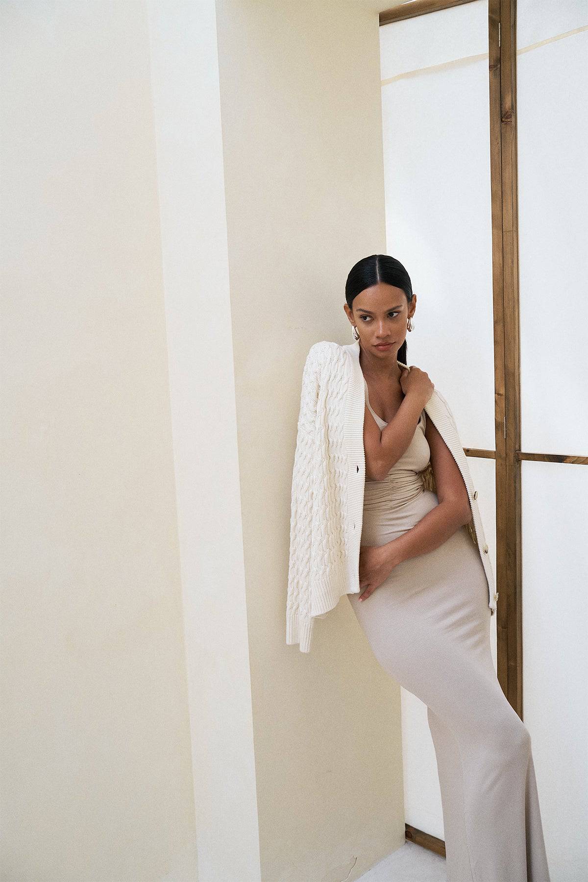 Riot Lounge Roxi Maxi Dress in coconut with soft ribbed fabric, flowing design, and sleeveless style on a hanger.