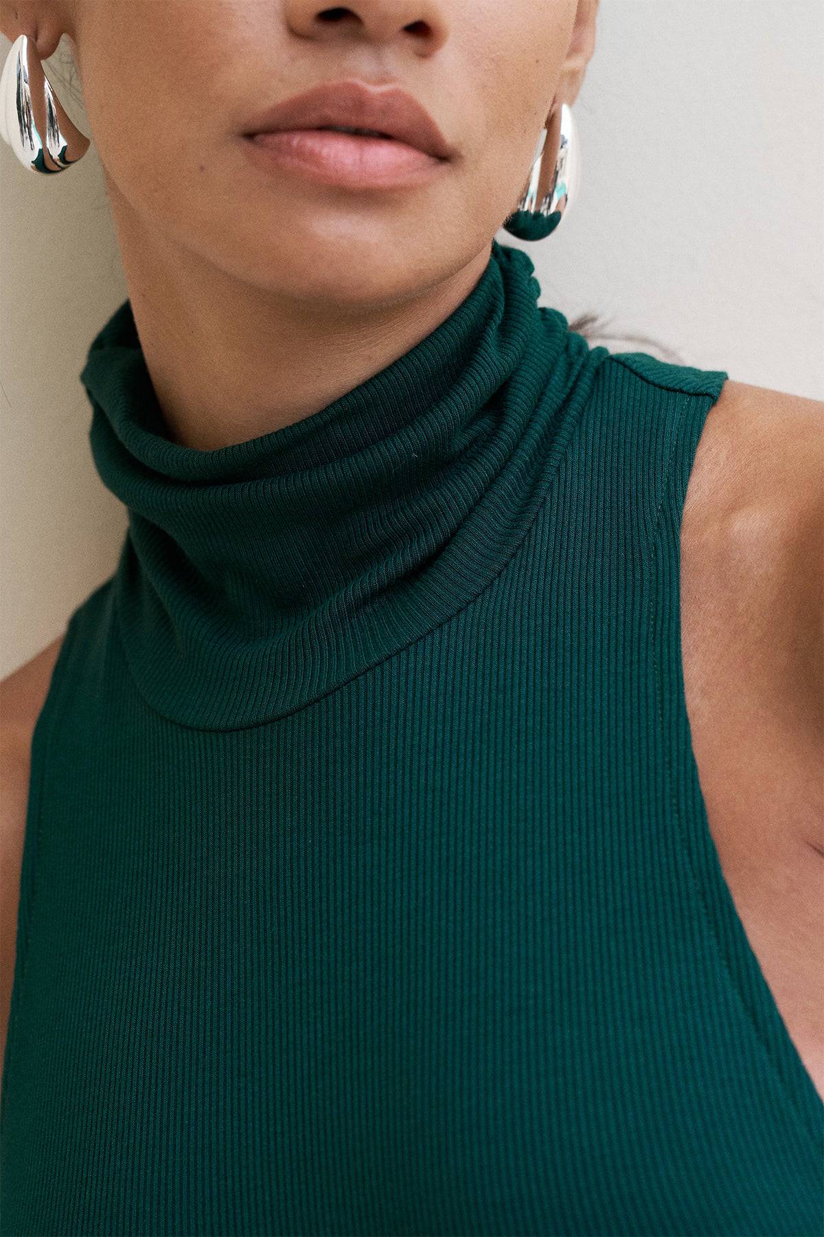 Riot Lounge Maeve Maxi Dress in forest green with soft ribbed fabric, flowing silhouette, and sleeveless design.