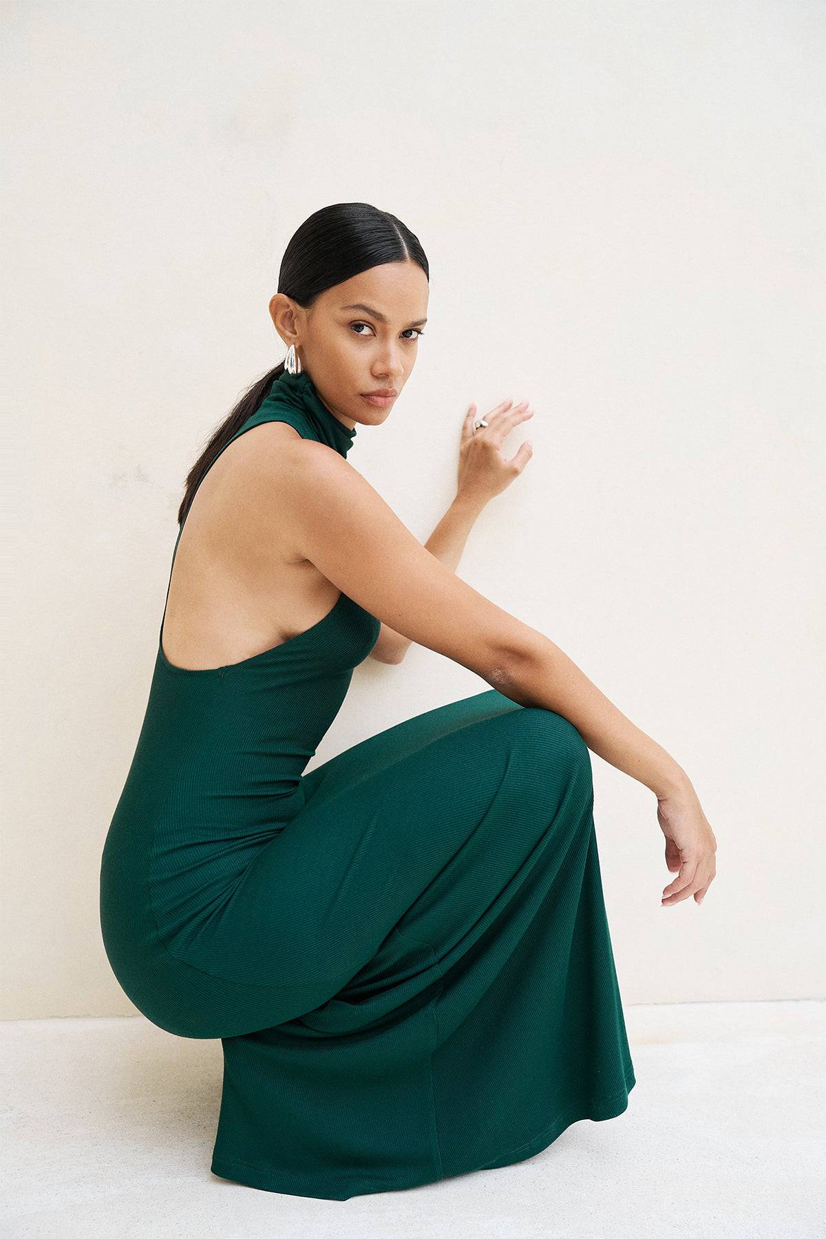 Riot Lounge Maeve Maxi Dress in forest green with soft ribbed fabric, flowing silhouette, and sleeveless design.