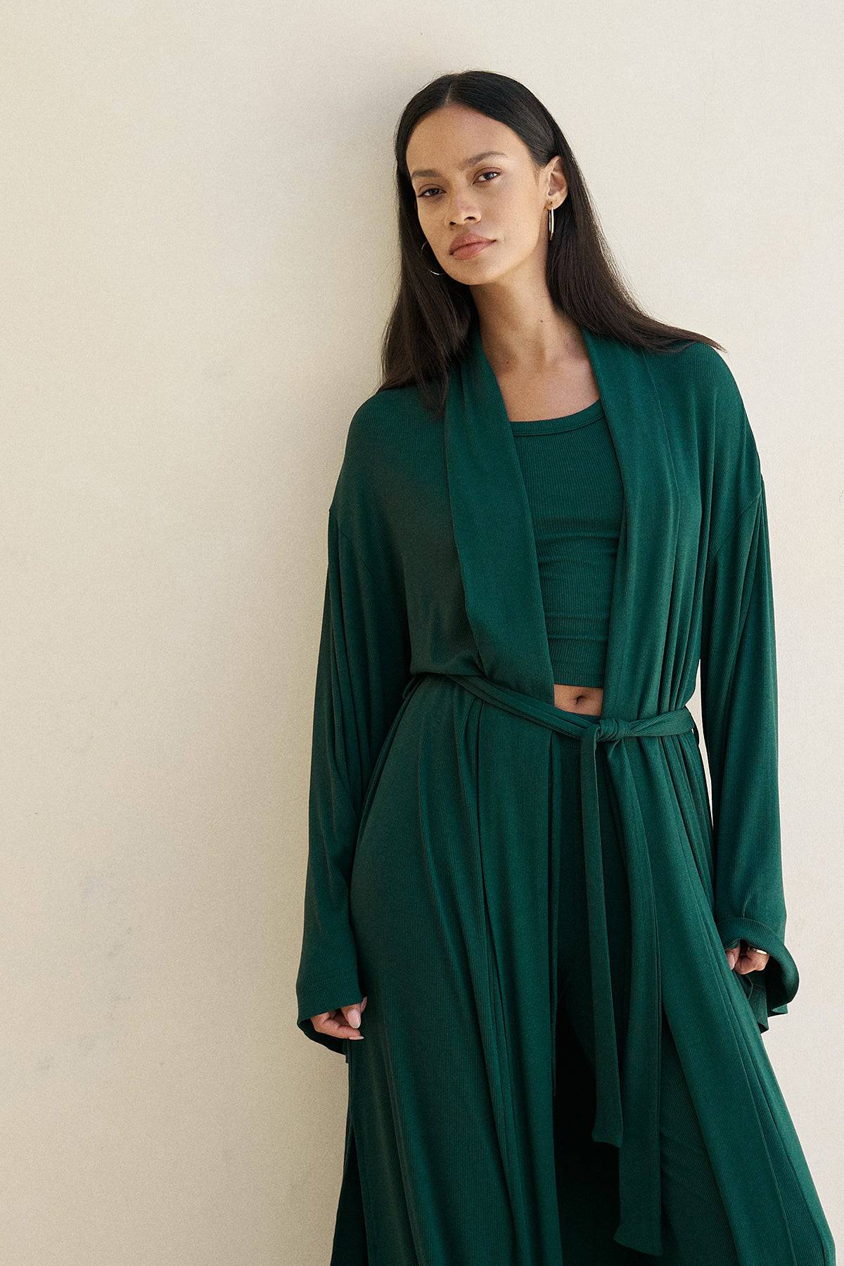 Forest green Riot Lounge Lina robe made of soft ribbed fabric, shown hanging with a relaxed, cozy fit.