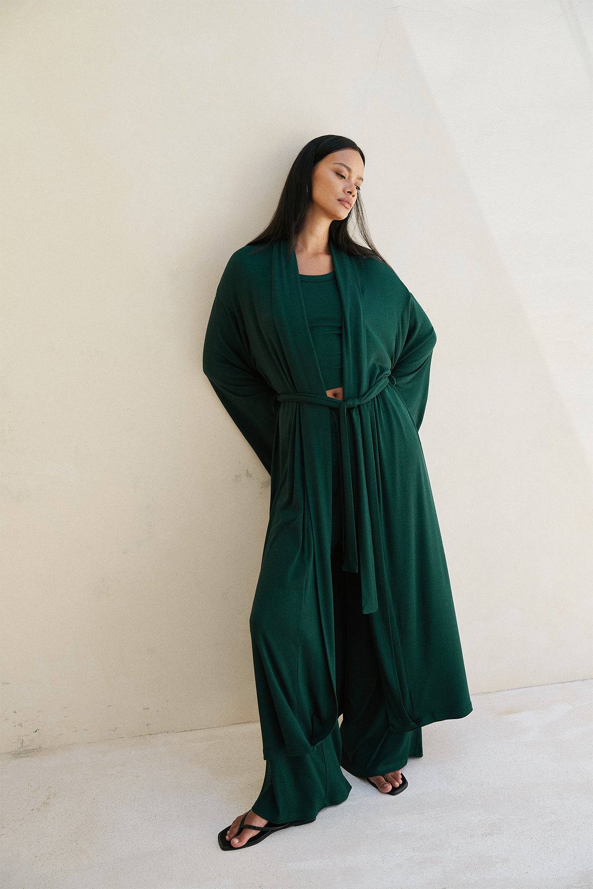 Forest green Lina Robe by Riot Lounge, featuring soft ribbed fabric and relaxed fit, shown hanging on a neutral background.