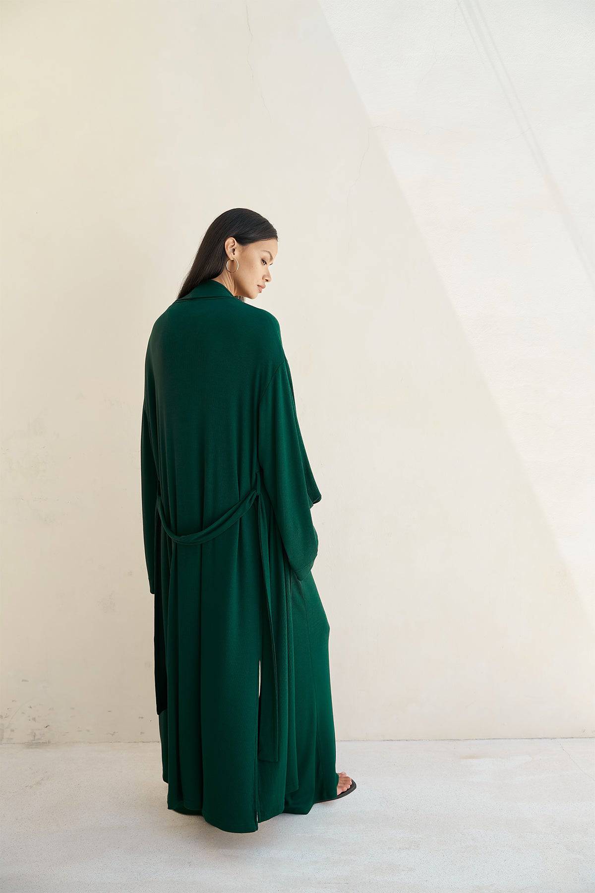 Forest green Riot Lounge Lina Robe with soft ribbed texture, shown hanging on a hook, highlighting its cozy, relaxed fit.